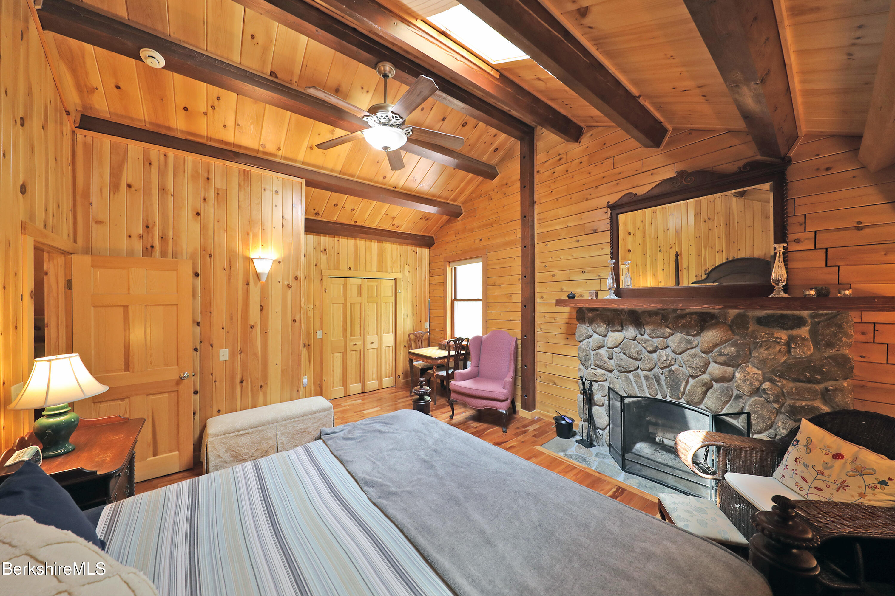 235 Algerie Road Becket, MA 01223 - Photo 19 of 43 a bedroom with furniture and a fireplace