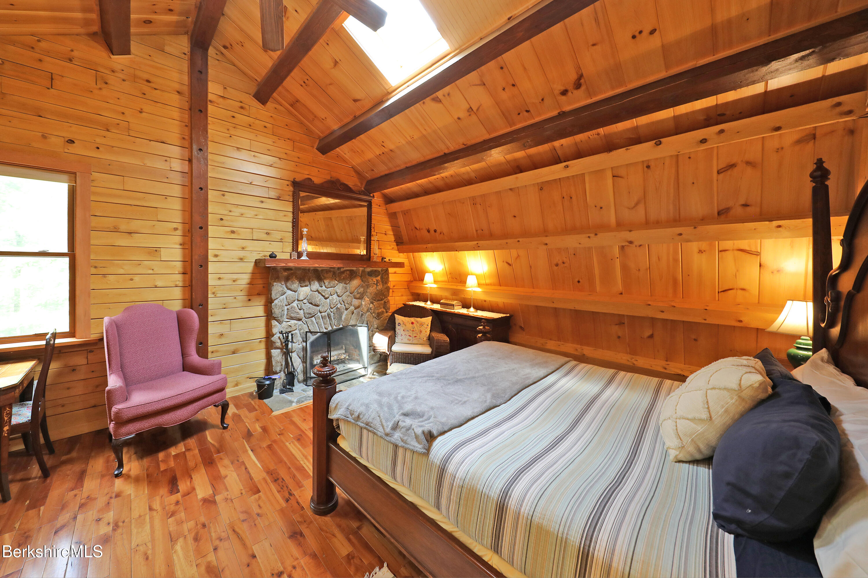 235 Algerie Road Becket, MA 01223 - Photo 21 of 43 a bedroom with a bed and a chair