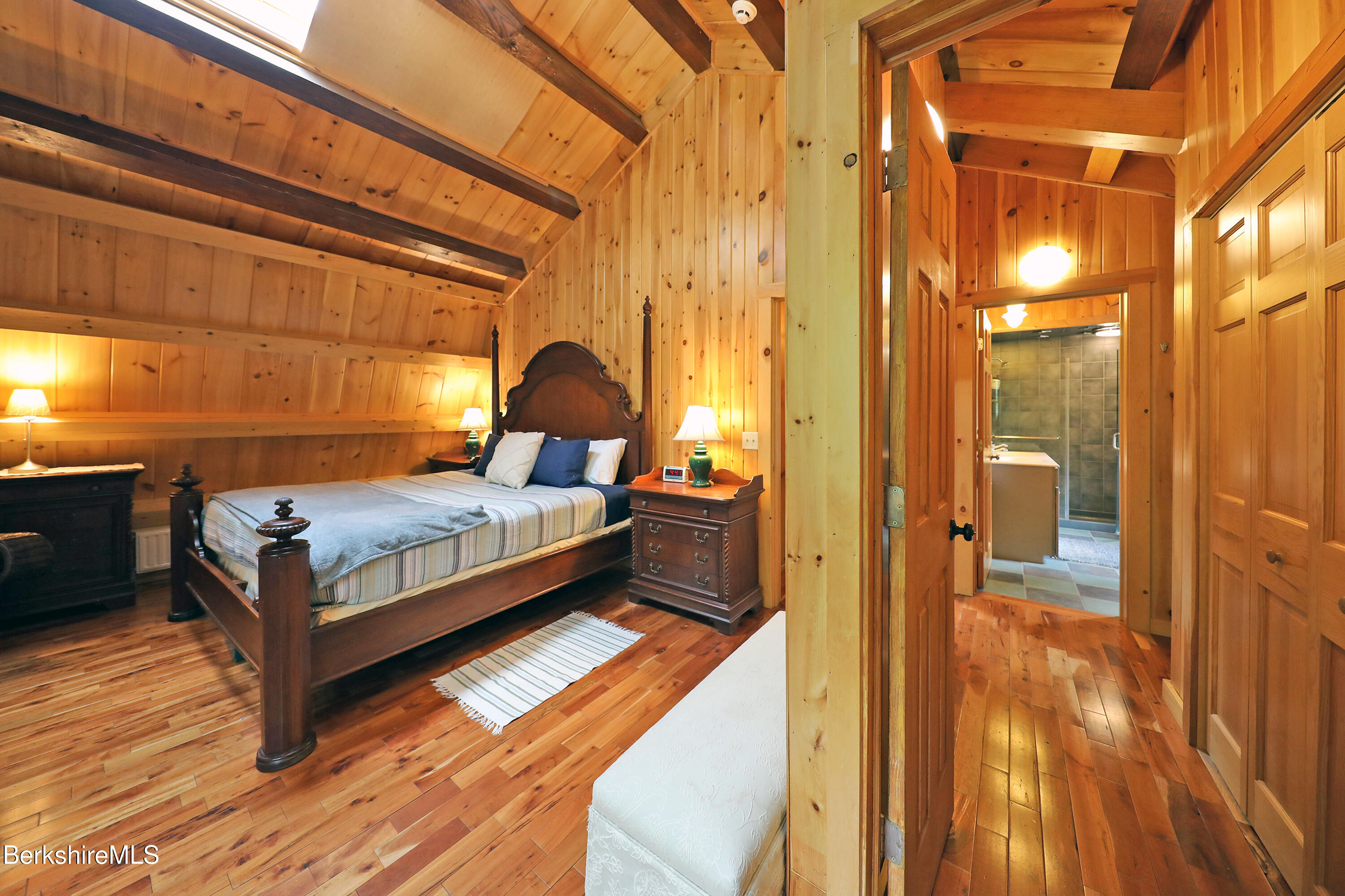 235 Algerie Road Becket, MA 01223 - Photo 22 of 43 a bedroom with a bed and wooden floor