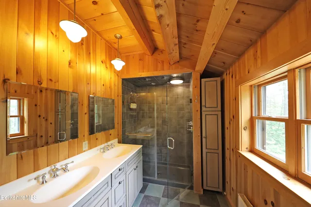 a bathroom with a double vanity sink toilet and shower