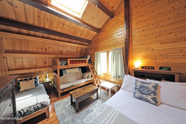 a bedroom with furniture and wooden floor