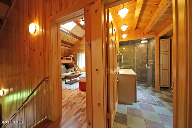 a view of a bathroom with shower and mirror