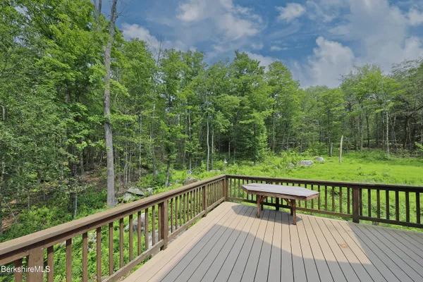 a view of a wooden deck with a yard