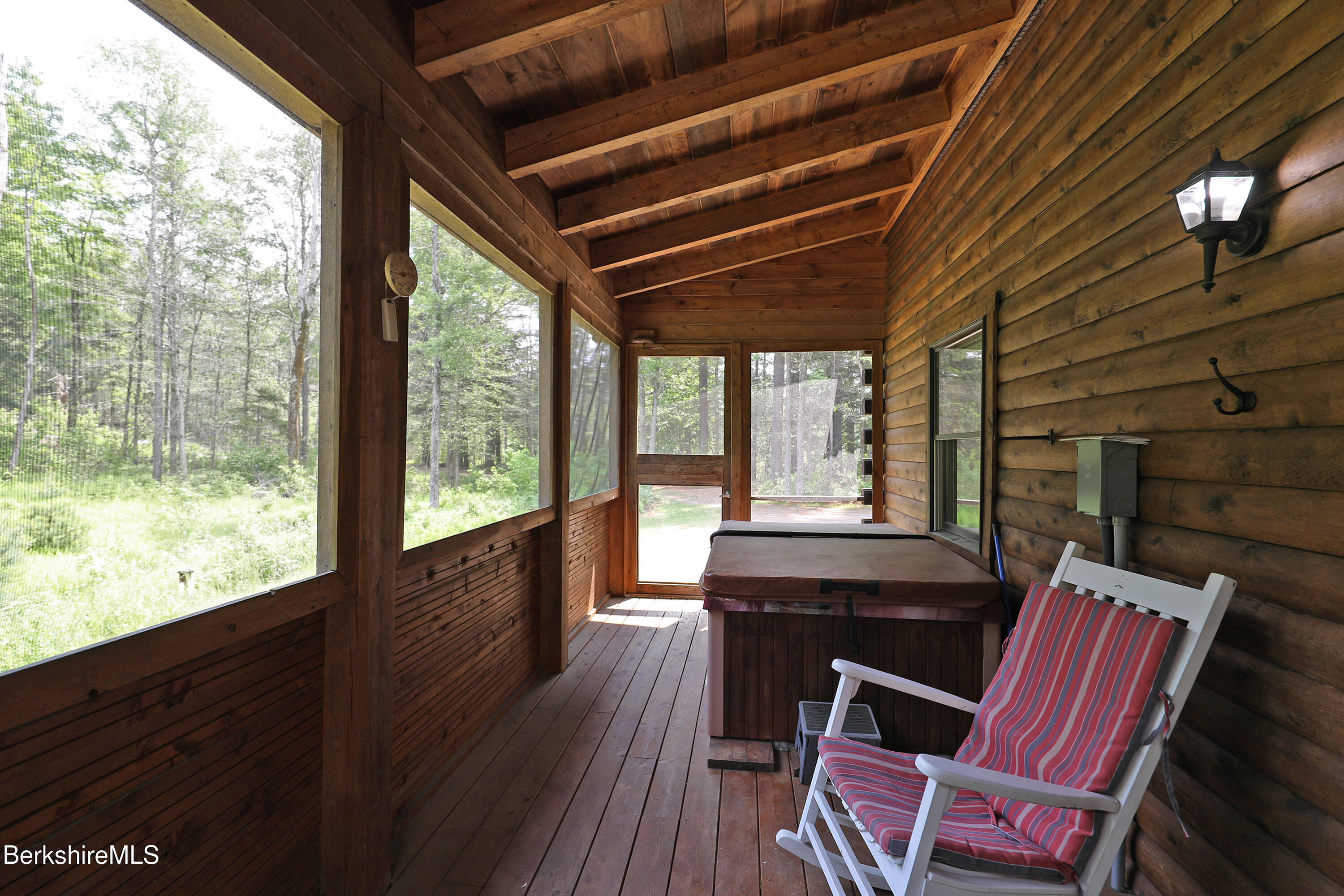 235 Algerie Road Becket, MA 01223 - Photo 37 of 43 a view of a patio with table and chairs with wooden floor and fence