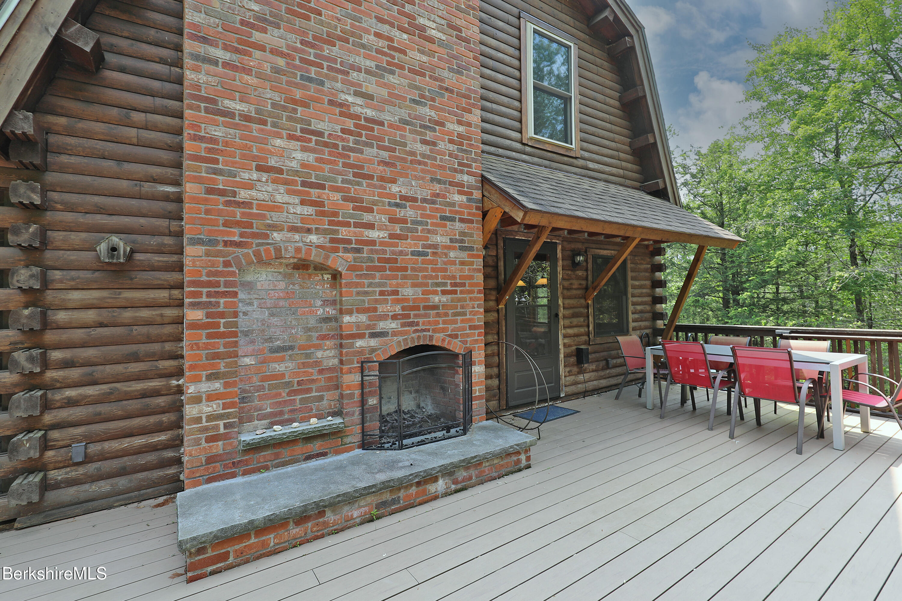 235 Algerie Road Becket, MA 01223 - Photo 39 of 43 a backyard of a house with wooden floor and outdoor seating