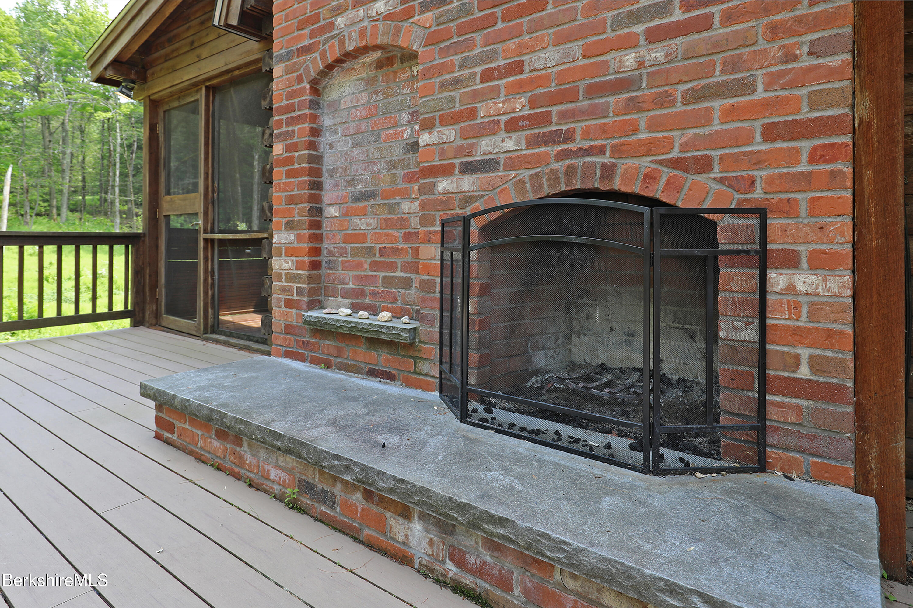 235 Algerie Road Becket, MA 01223 - Photo 4 of 43 a brick building with a bench in front