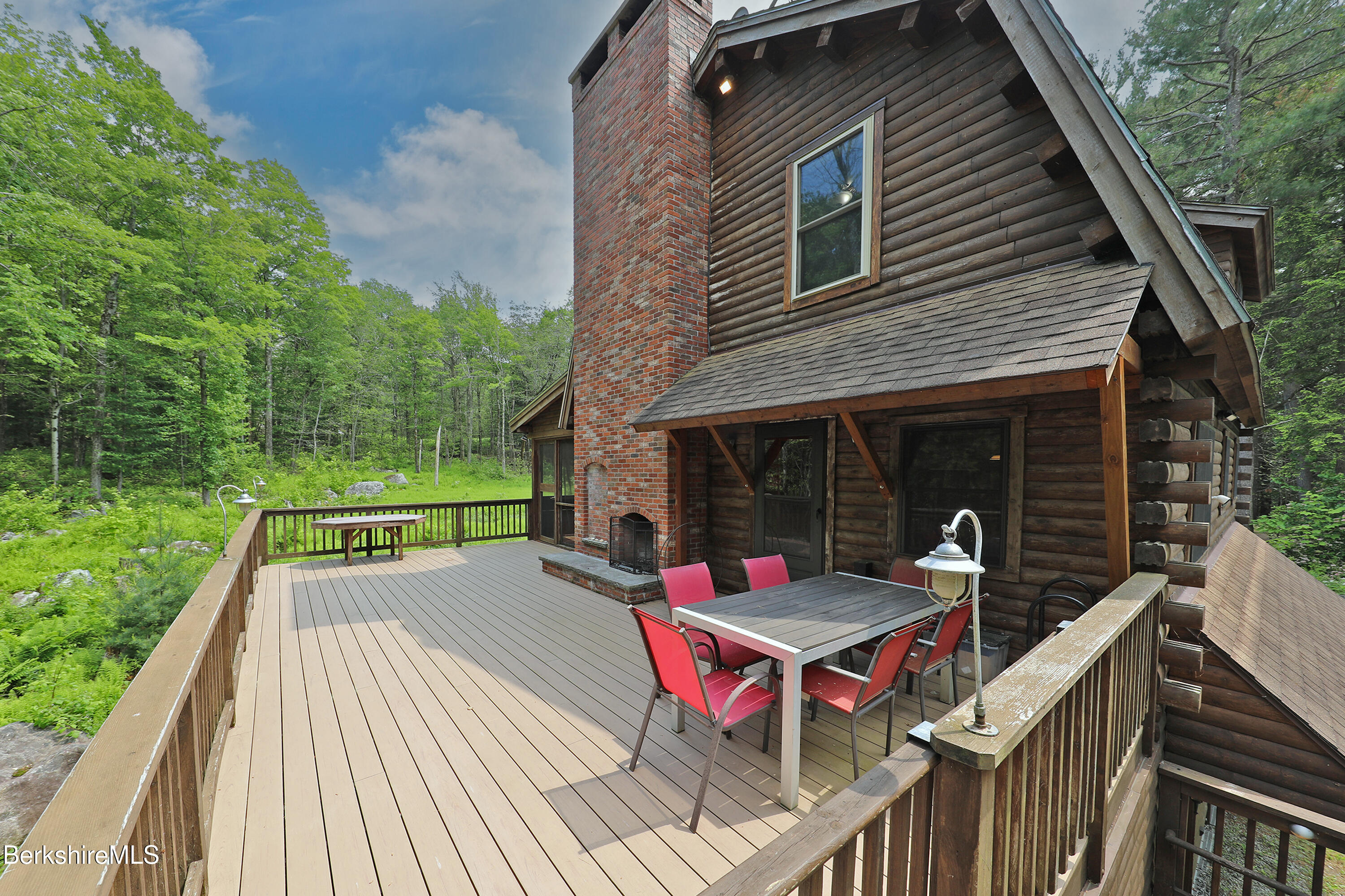 235 Algerie Road Becket, MA 01223 - Photo 5 of 43 a view of house with wooden deck and furniture