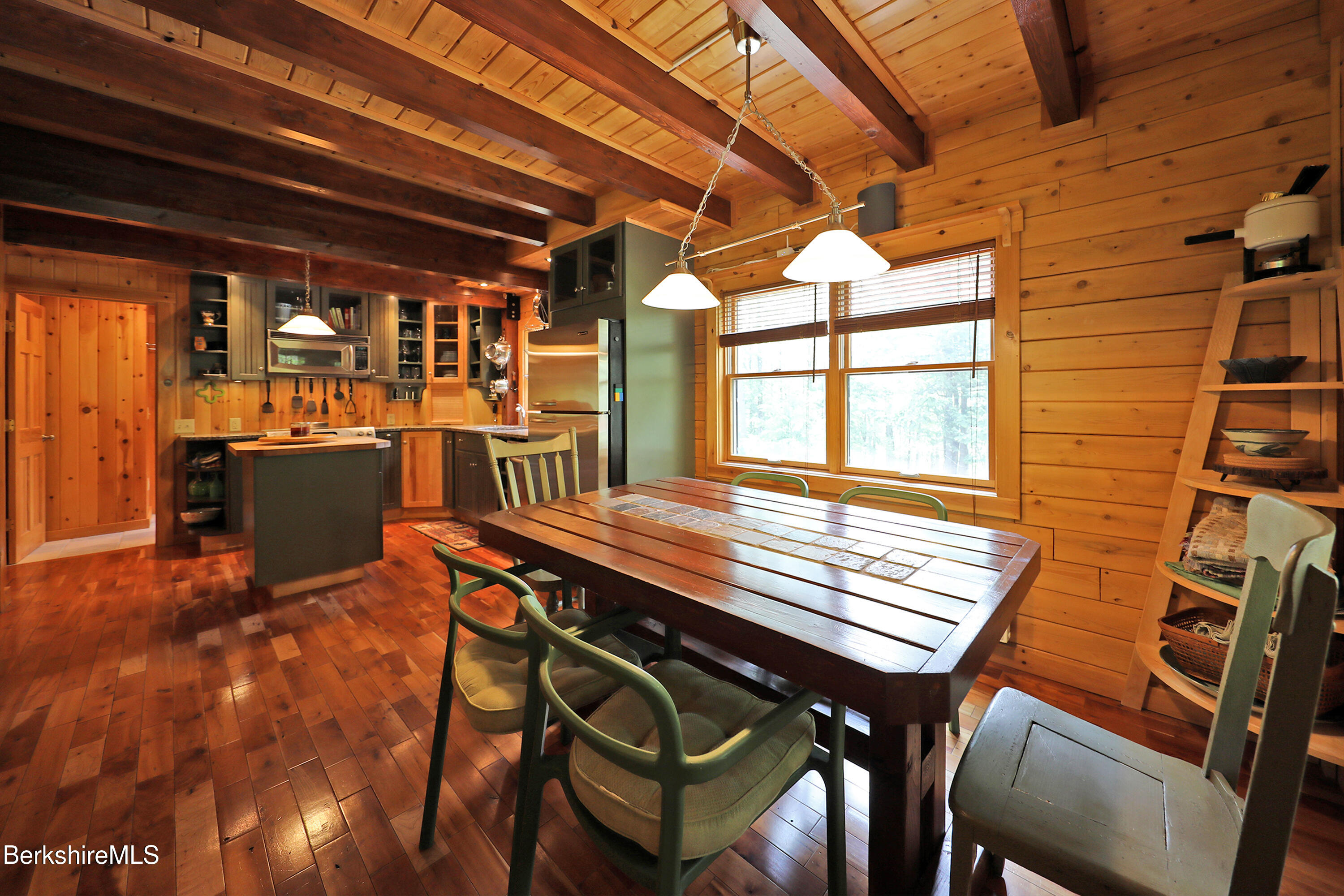 235 Algerie Road Becket, MA 01223 - Photo 10 of 43 a dining room with a wooden table and chairs