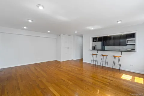 a view of kitchen with stainless steel appliances refrigerator stove microwave and cabinets