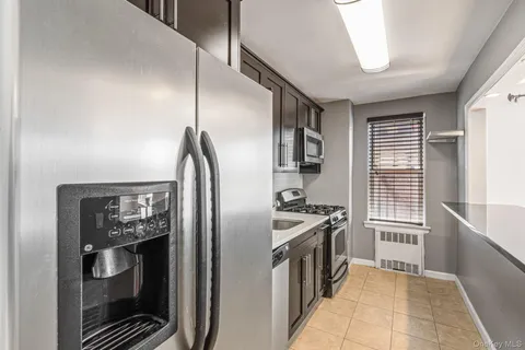 a kitchen with stainless steel appliances granite countertop a stove and a refrigerator