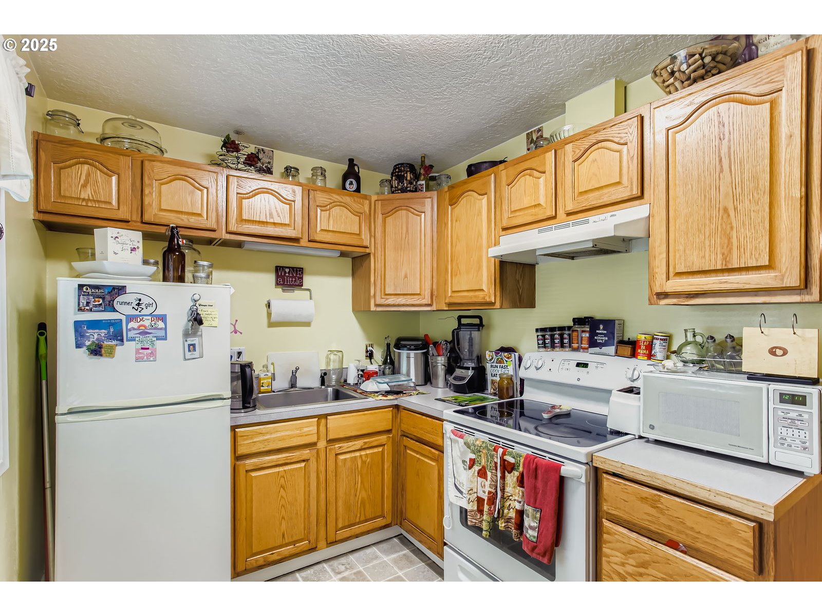 14555 Northeast Knott Court Portland, OR 97230 - Photo 27 of 40 a kitchen with stainless steel appliances granite countertop a sink and a refrigerator
