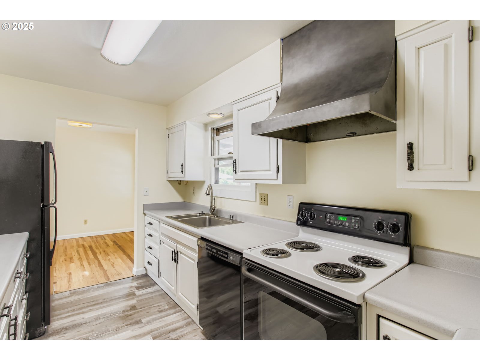 14555 Northeast Knott Court Portland, OR 97230 - Photo 5 of 40 a kitchen with stainless steel appliances a stove a sink and a refrigerator