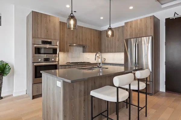 a kitchen with kitchen island a large counter top space appliances and cabinets