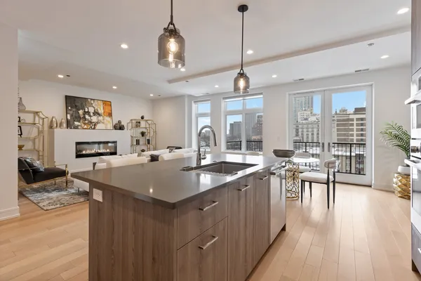 a kitchen with sink stove and wooden floor