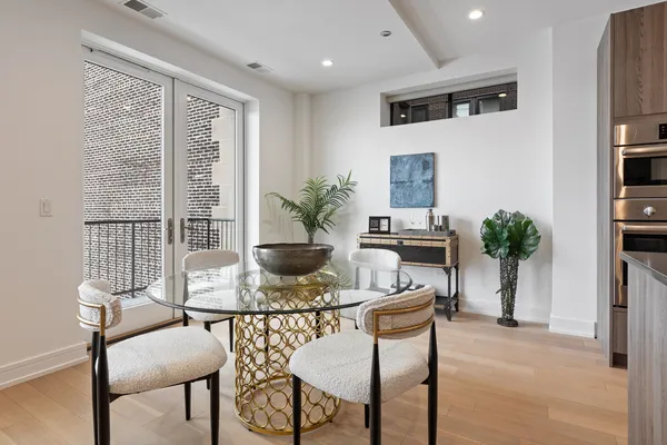 a dining room with furniture and wooden floor