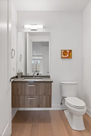 a bathroom with a toilet a sink and mirror