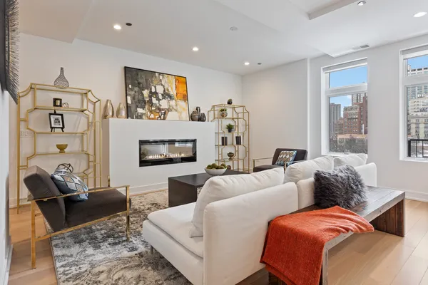 a living room with furniture a window and a flat screen tv
