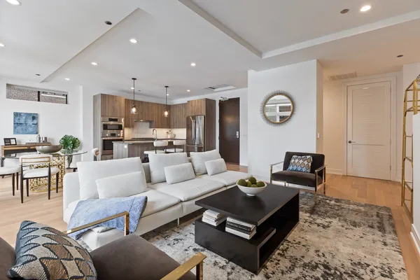 a living room with furniture kitchen view and a table