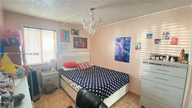 a bedroom with furniture and a large window