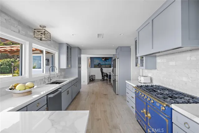 a kitchen with stainless steel appliances granite countertop a stove and a sink