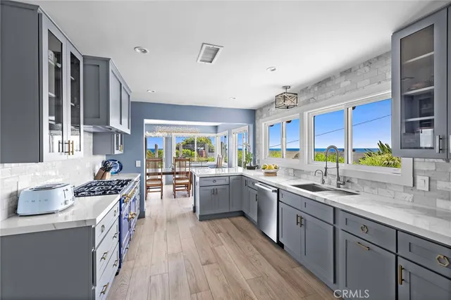 a kitchen with a sink stove top oven and cabinets
