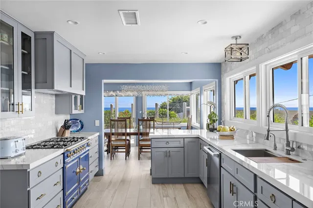 a kitchen with a stove a sink a refrigerator and wooden cabinets