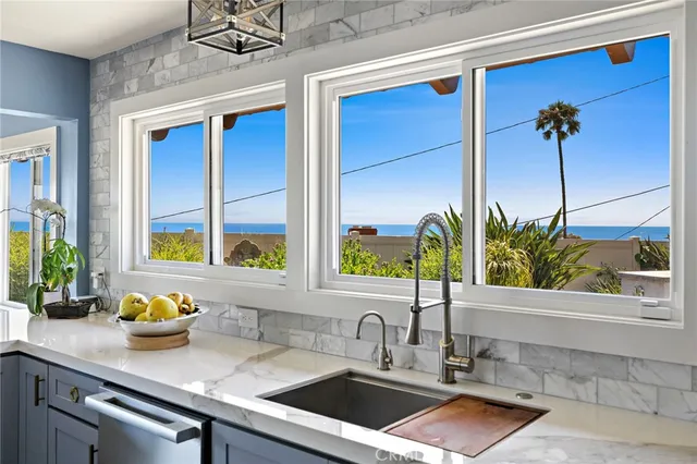 a kitchen with a sink a counter and a window