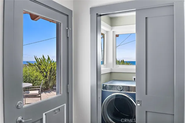 a view of a hallway with washer and dryer