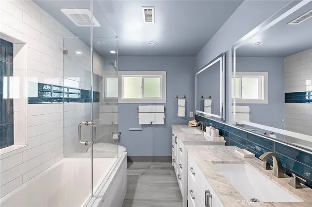 a bathroom with a tub sink and mirror