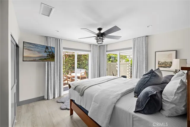 a bedroom with a bed and a large window