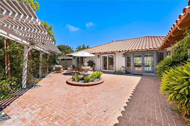 a front view of a house with garden and patio