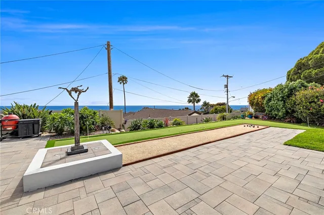 a view of a road with a bench and trees