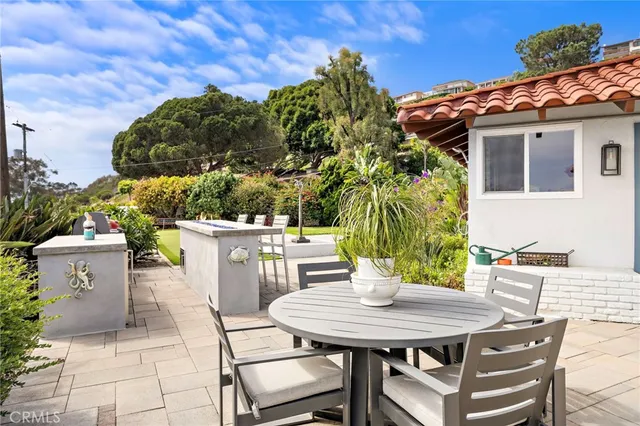 a view of a patio with table and chairs and potted plants
