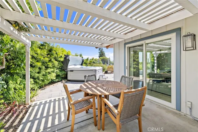 a view of a patio with table and chairs and potted plants