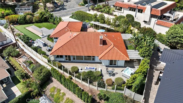 an aerial view of residential houses with outdoor space and street view