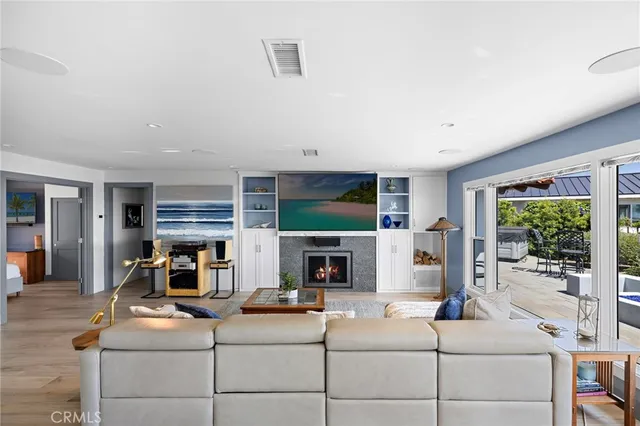 a living room with fireplace furniture and a flat screen tv