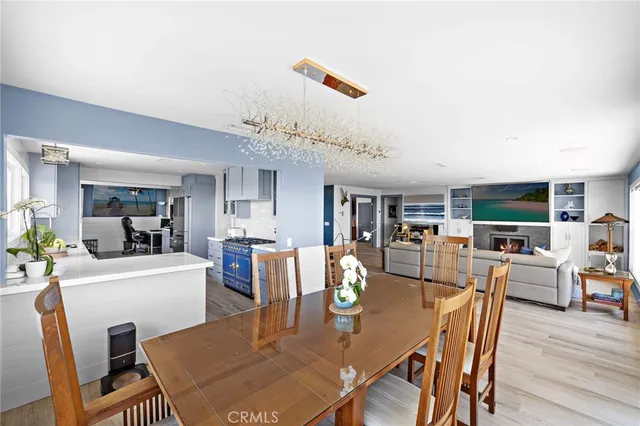 a dining room with furniture a rug and wooden floor