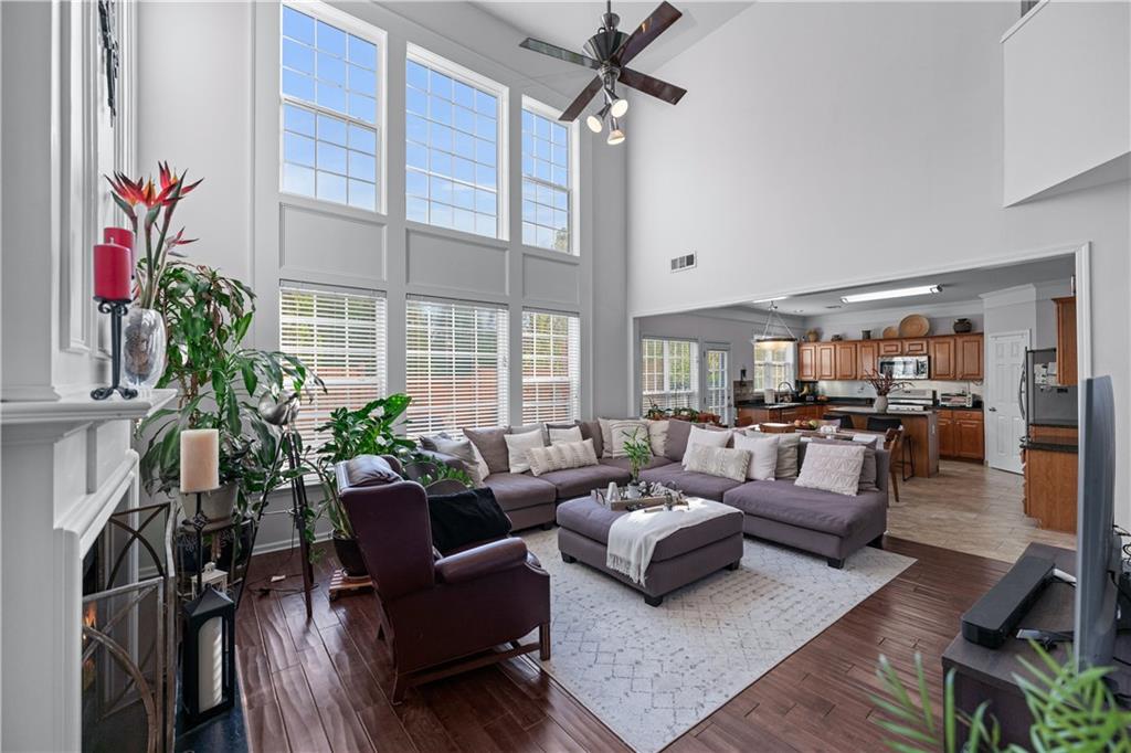 135 Splinter Court Suwanee, GA 30024 - Photo 11 of 47 a living room with furniture potted plant and a large window