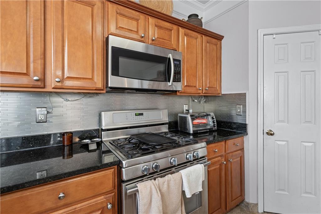 135 Splinter Court Suwanee, GA 30024 - Photo 15 of 47 a kitchen with stainless steel appliances granite countertop a stove and a microwave
