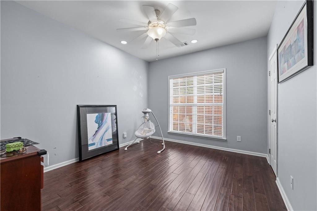 135 Splinter Court Suwanee, GA 30024 - Photo 17 of 47 an empty room with wooden floor and windows