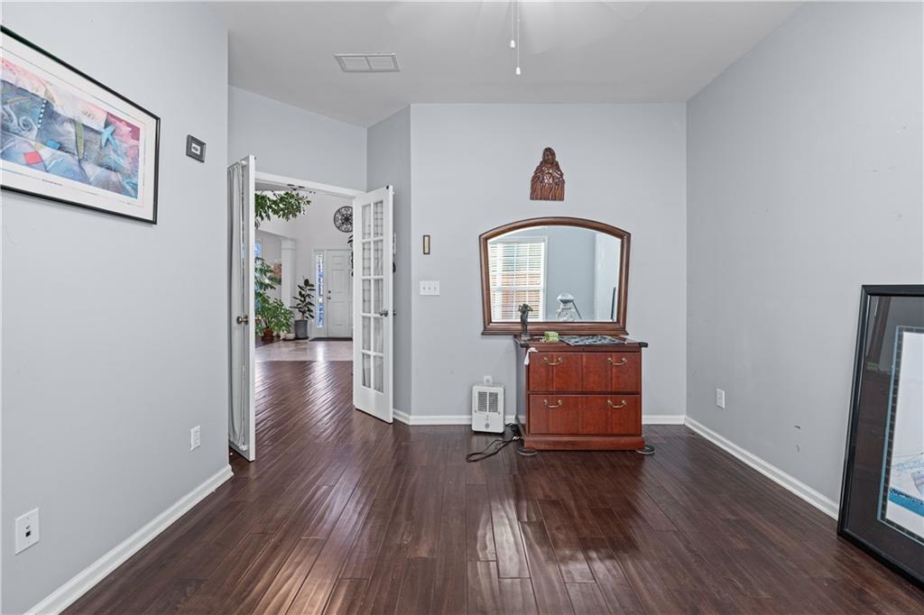 135 Splinter Court Suwanee, GA 30024 - Photo 18 of 47 an empty room with piano and wooden floor