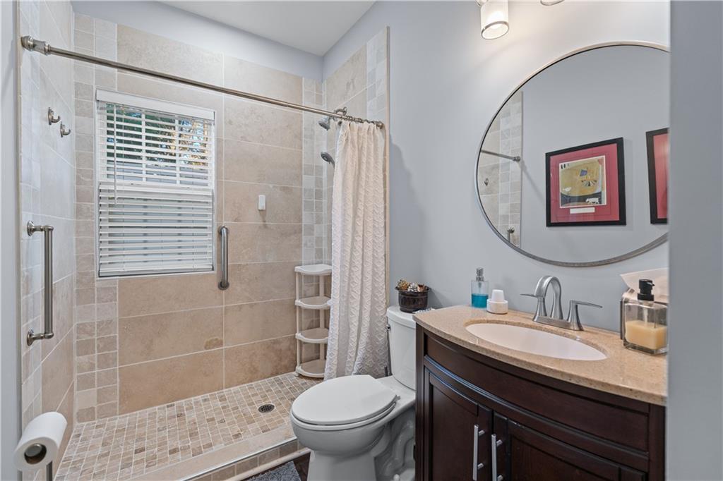 135 Splinter Court Suwanee, GA 30024 - Photo 19 of 47 a bathroom with a sink a toilet and shower