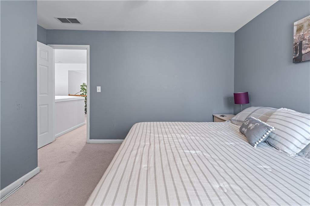 135 Splinter Court Suwanee, GA 30024 - Photo 24 of 47 a bedroom with a bed and a table