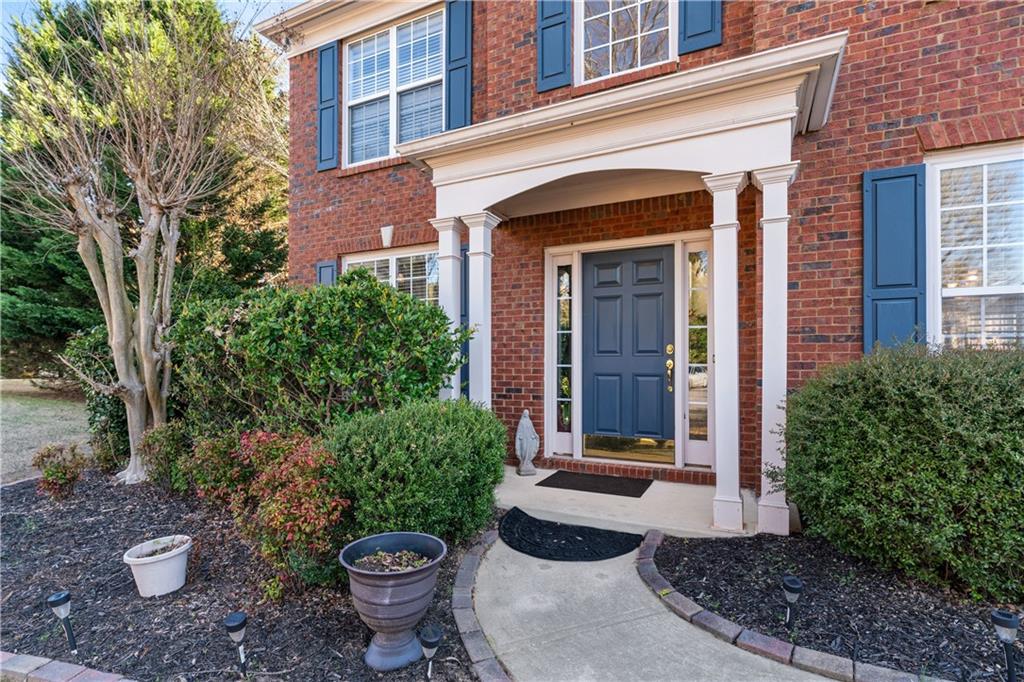 135 Splinter Court Suwanee, GA 30024 - Photo 3 of 47 a view of a backyard with plants and a fountain