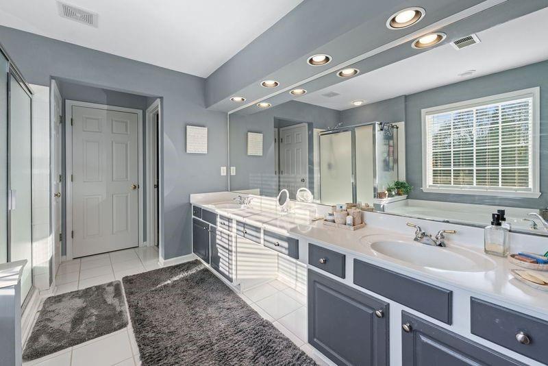 135 Splinter Court Suwanee, GA 30024 - Photo 32 of 47 a spacious bathroom with a double vanity sink and a mirror