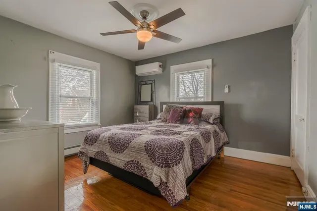 a bedroom with a bed mirror and a window