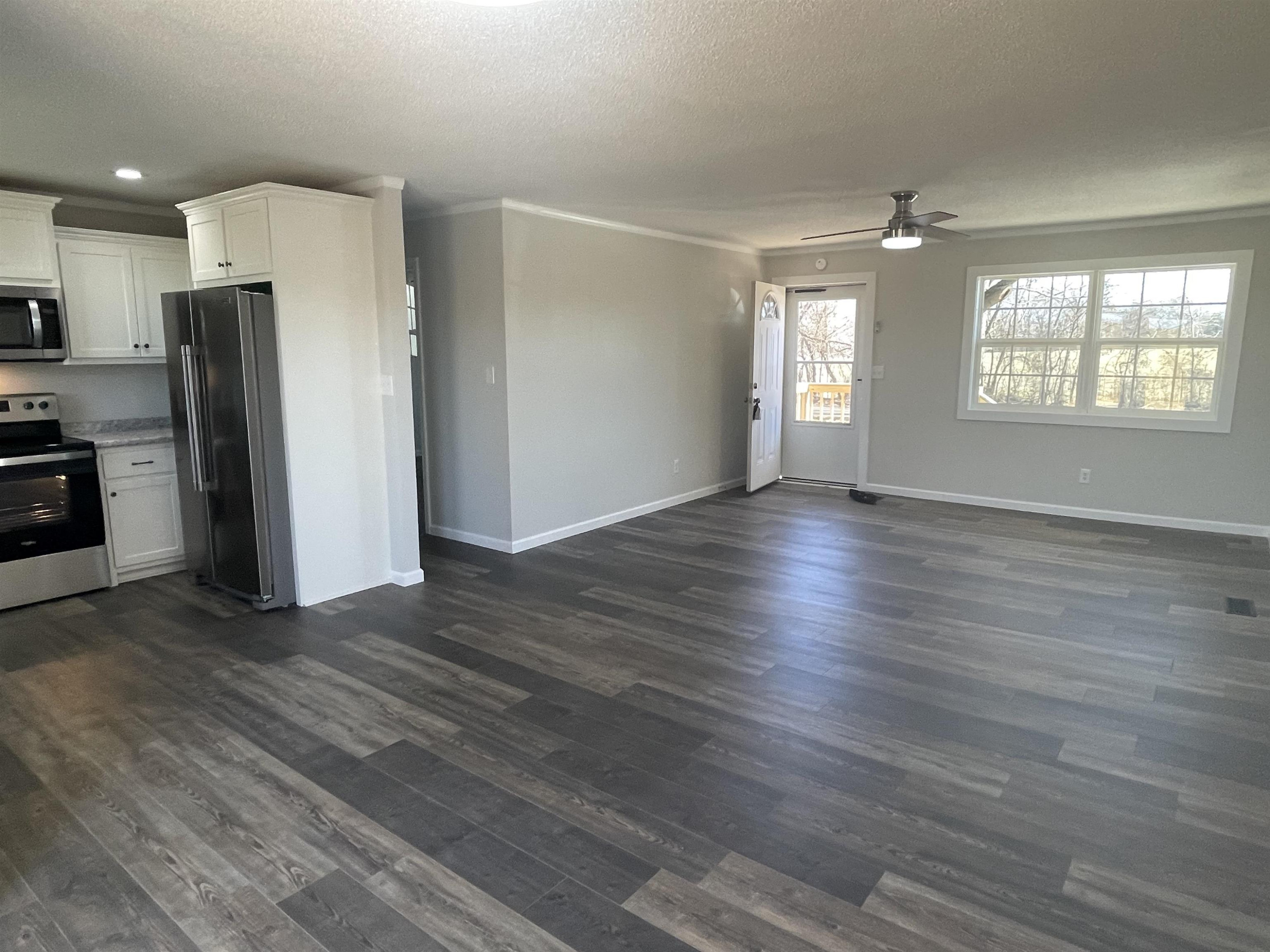 5677 Tatumville Road Newbern, TN 38059 - Photo 3 of 16 an empty room with wooden floor and windows