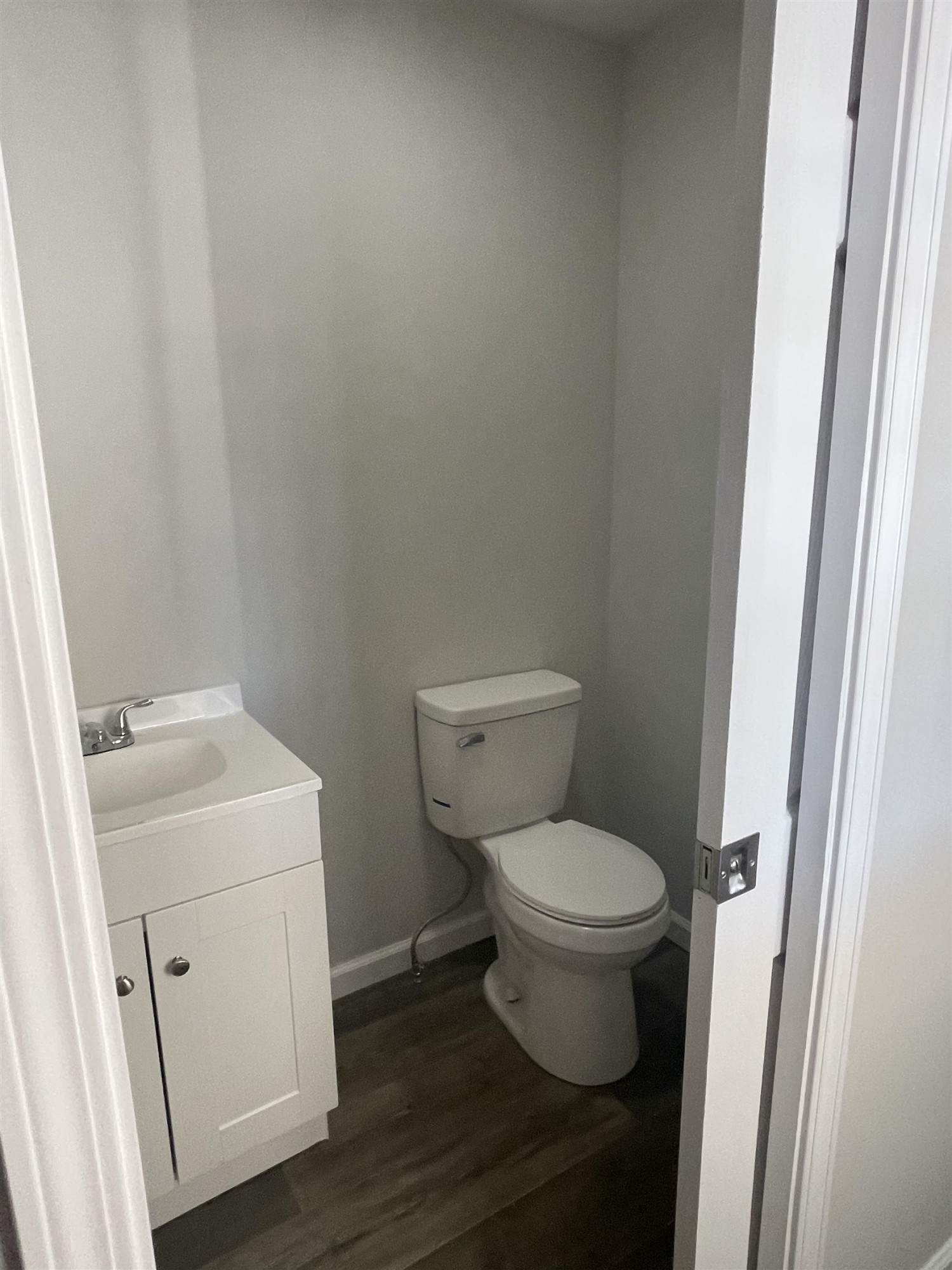 5677 Tatumville Road Newbern, TN 38059 - Photo 5 of 16 a white toilet sitting next to a white sink and vanity