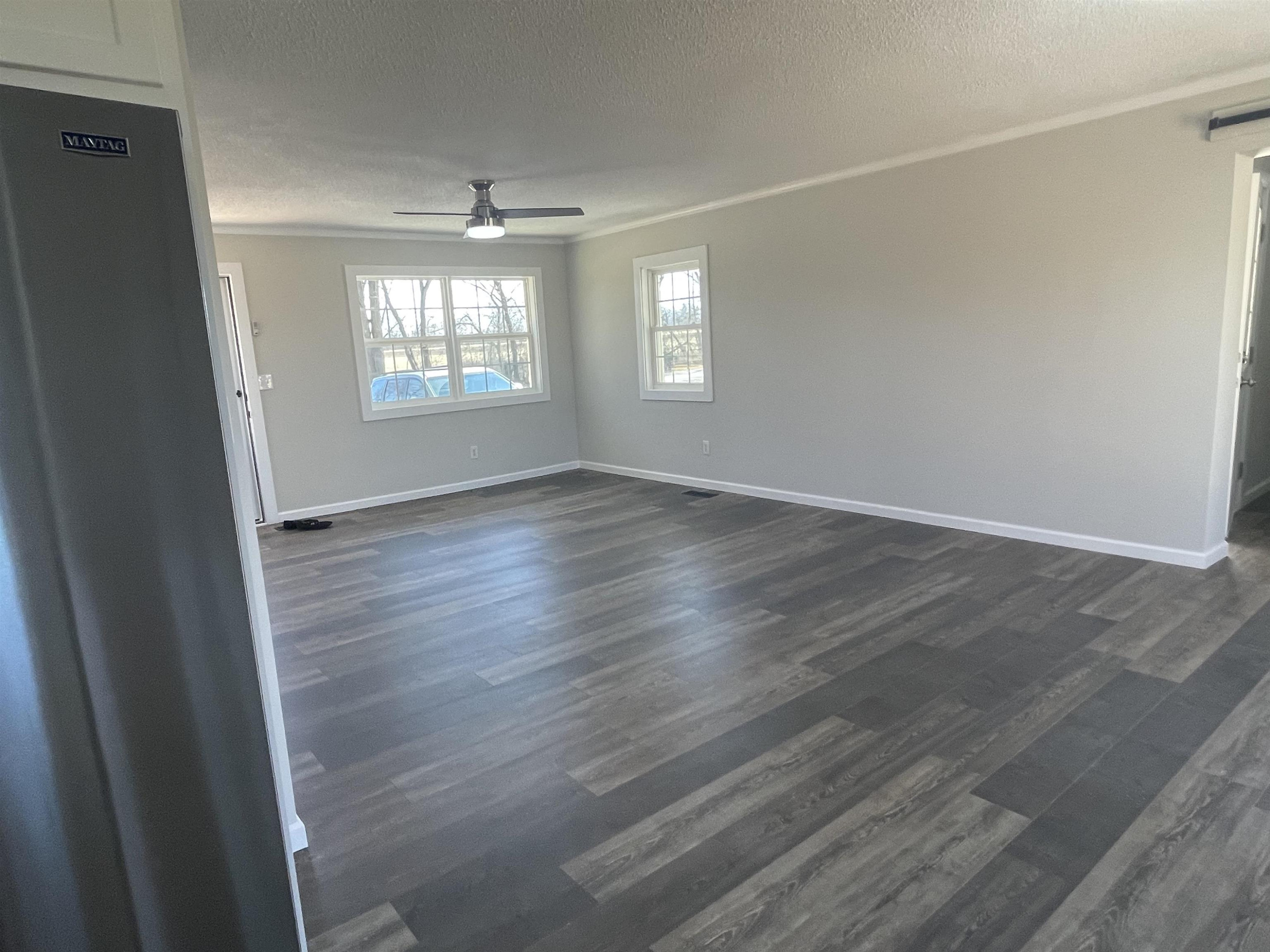 5677 Tatumville Road Newbern, TN 38059 - Photo 8 of 16 an empty room with wooden floor and windows