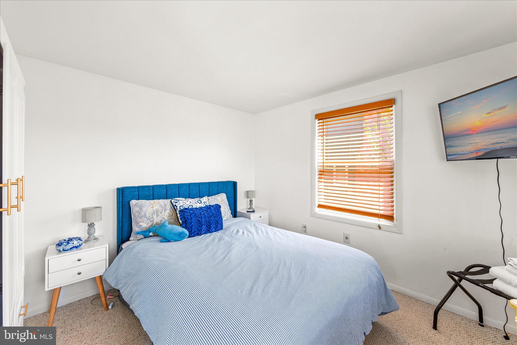 21406 Dogwood Cove Road Tilghman, MD 21671 - Photo 14 of 68 a bedroom with a bed and a flat screen tv